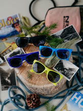 Load image into Gallery viewer, glacier raft company sunglasses in black, blue, purple and yellow