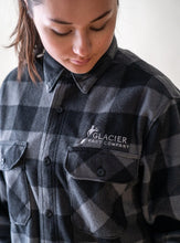 Load image into Gallery viewer, glacier raft company logo on grey plaid fleece