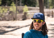 Load image into Gallery viewer, Guy wearing Glacier Raft Company flat brim mountain scene hat