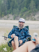 Load image into Gallery viewer, wearing blue plaid fleece by the kicking horse river from glacier raft company golden bc