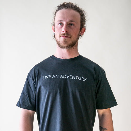 male model wearing Glacier Raft Company live an adventure t-shirt