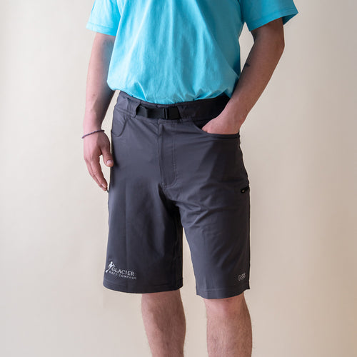 male model wearing Glacier Raft Company NRS guide shorts