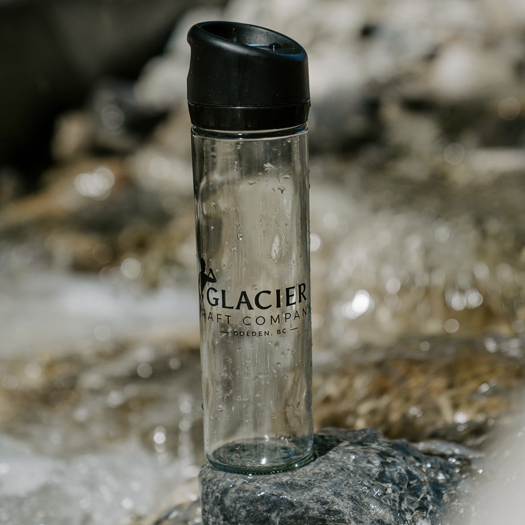 glass water bottle with glacier raft company logo