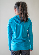 Load image into Gallery viewer, model showing back of NRS women&#39;s silkweight hoodie
