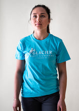 Load image into Gallery viewer, female model wearing teal glacier raft company logo t-shirt
