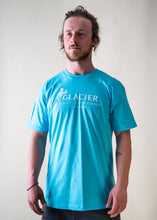 Load image into Gallery viewer, male model wearing teal glacier raft company logo t-shirt
