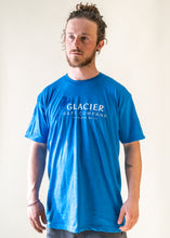 Load image into Gallery viewer, male model wearing blue glacier raft company logo t-shirt
