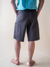 Load image into Gallery viewer, model showing back of men&#39;s guide shorts glacier raft company
