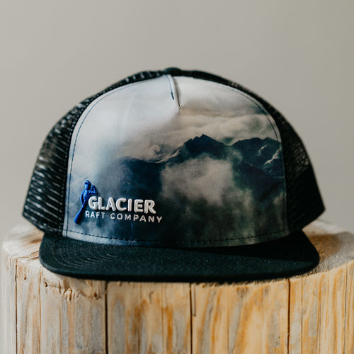mountain scene on flat brim glacier raft company hat